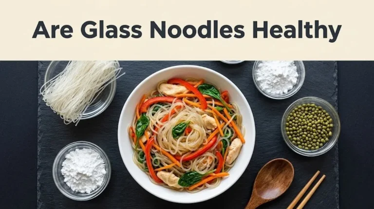 An overhead flat-lay of cooked glass noodles with vegetables and dry starch ingredients, with the headline Are Glass Noodles Healthy
