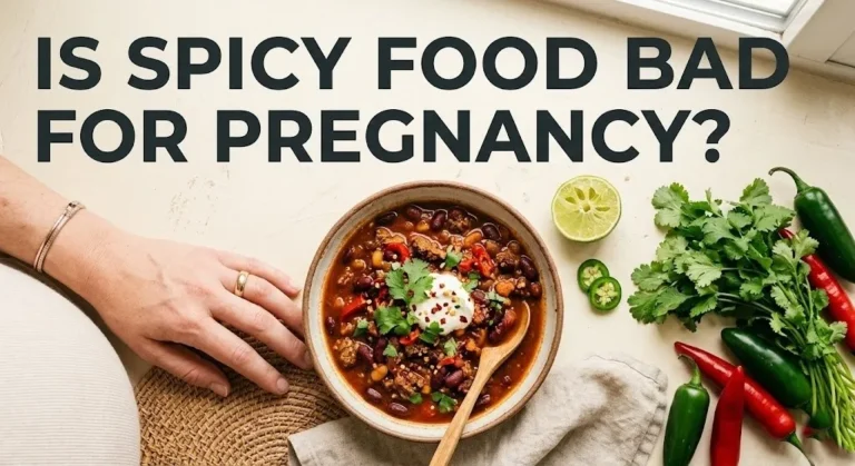 Bowl of spicy curry surrounded by chili peppers and lime, with text asking is spicy food bad for pregnancy.