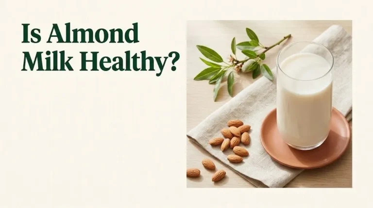Is almond milk healthy guide showing a glass of almond milk with raw almonds on a cream background, 2026 nutrition overview