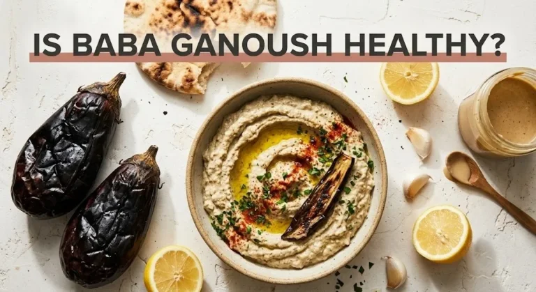 Overhead flat-lay of baba ganoush in a bowl with charred eggplants and olive oil. Text reads Is Baba Ganoush Healthy.